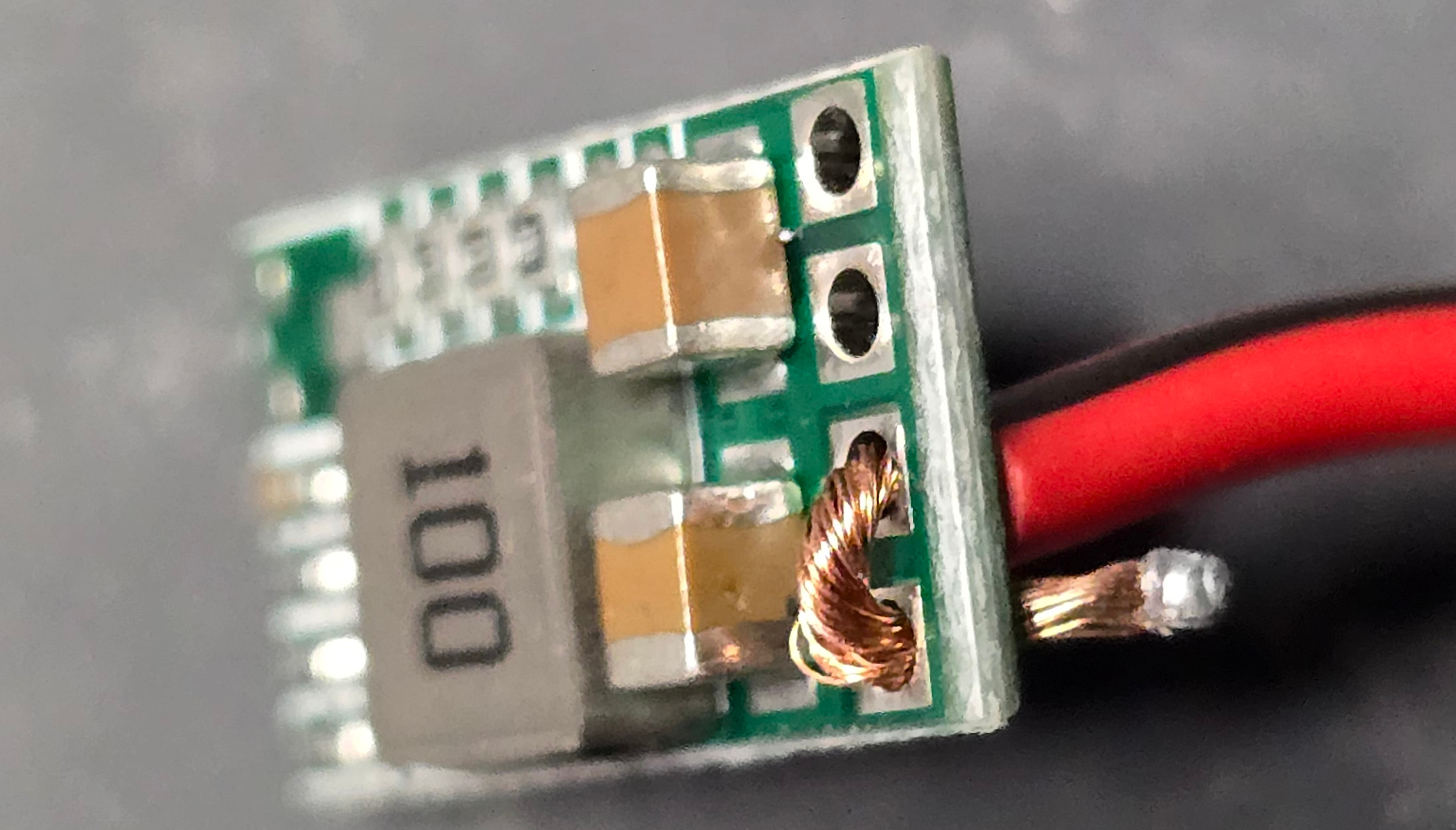 Side view of positive wire inserted into board Side view of positive wire placement